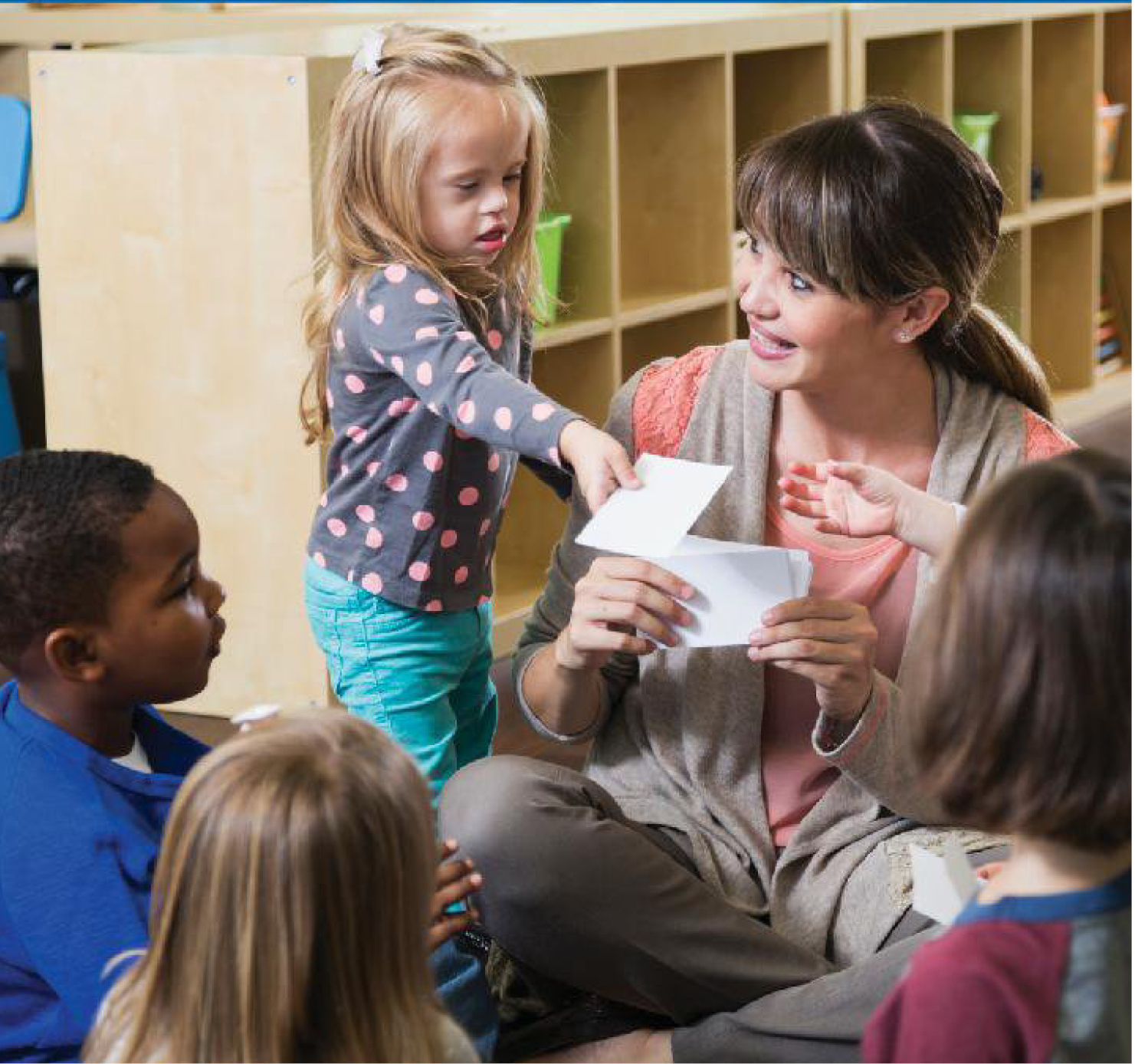 teacher assisting small child student