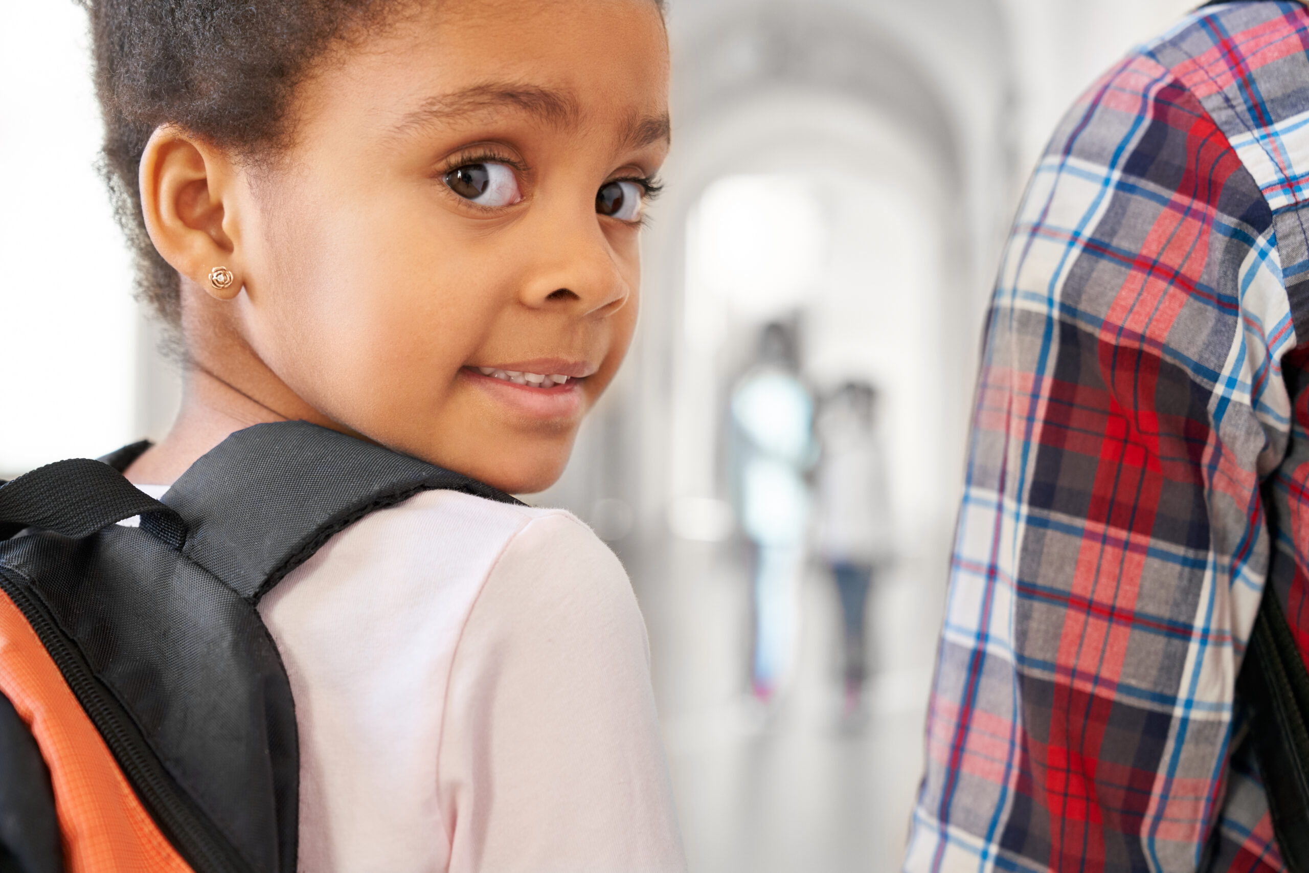 school girl looking at camera over shoulder.